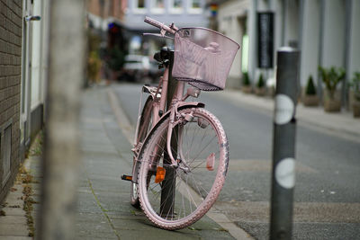 Bicycle parked on sidewalk in city