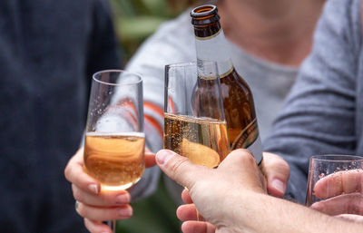 Midsection of man drinking beer glass