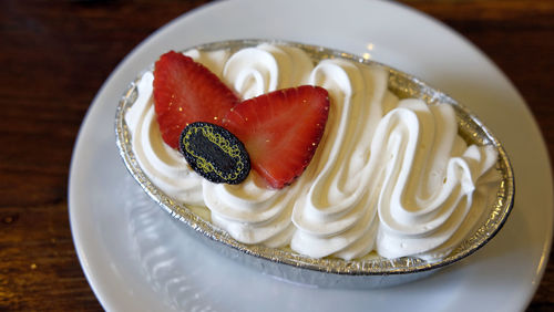 High angle view of cream cheese decorated dessert on plate
