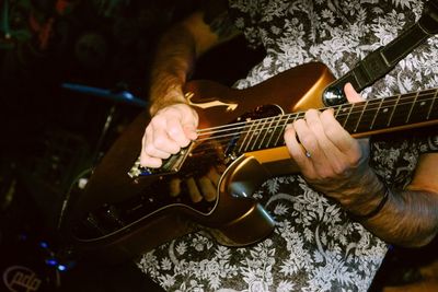 Cropped image of man playing guitar