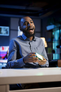 Young man using mobile phone in cafe