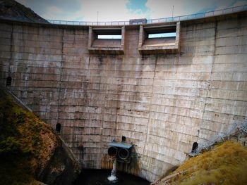 Low angle view of water reservoir wall