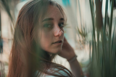 Portrait of woman standing by plants