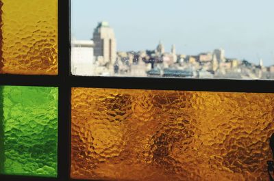 Close-up of cityscape against window