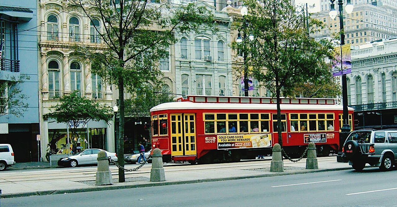 CARS ON ROAD BY BUILDINGS