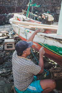 High angle view of man sitting on boat