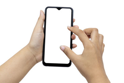 Low section of person holding smart phone against white background