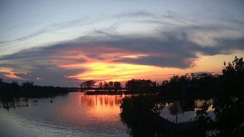 Scenic view of lake against romantic sky at sunset