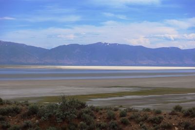 Scenic view of lake and mountains against sky