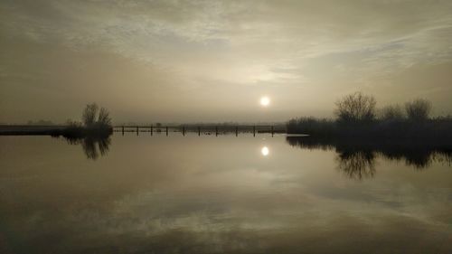 Scenic view of lake against sky during sunset