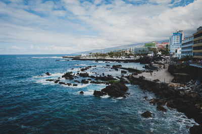 Scenic view of sea against cloudy sky