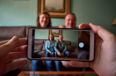 Middle-aged couple poses and smiles for a photo at home