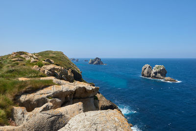 A beautiful view of cliffs surrounded by turquoise blue waters.