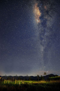 Scenic view of field against sky at night