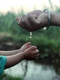 Close-up of hand holding water