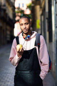 Portrait of young man holding apple