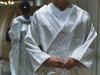 Bride wearing traditional kimono reflecting in mirror