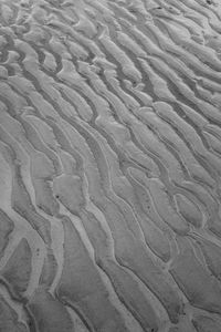 High angle view of tire tracks on sand