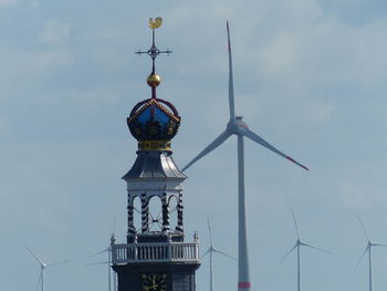 Low angle view of communications tower against sky