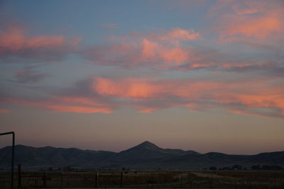 Scenic view of field against sky during sunset