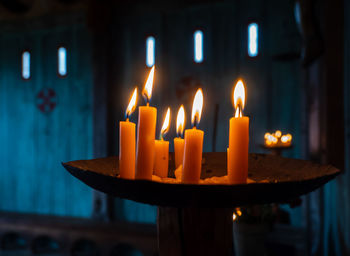 Close-up of burning candles in temple