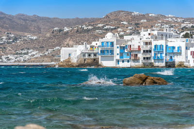 Scenic view of sea against buildings