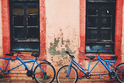 Close-up of bicycle against red house