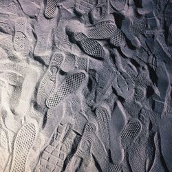 High angle view of footprints on sand