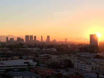 Cityscape against sky during sunset