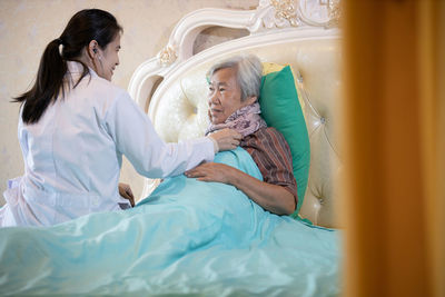 Woman lying on bed