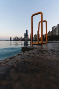 Surface level of railing at harbor by sea