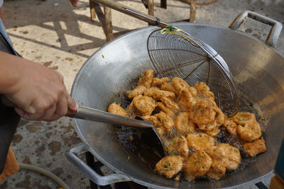 High angle view of person preparing food on barbecue grill