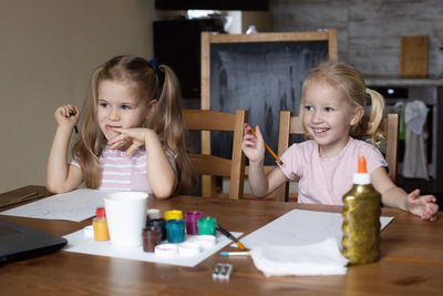 Cute boy playing with toy on table