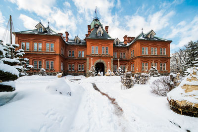 Snow covered building against sky