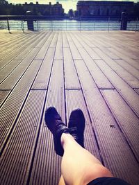 Low section of man standing on tiled floor