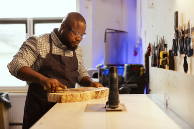 Side view of man working at table