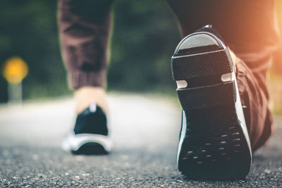 Low section of man wearing shoes