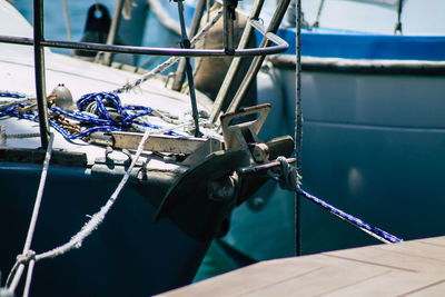 Close-up of rope tied to moored at harbor