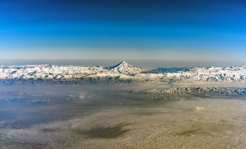 Scenic view of mountains against blue sky