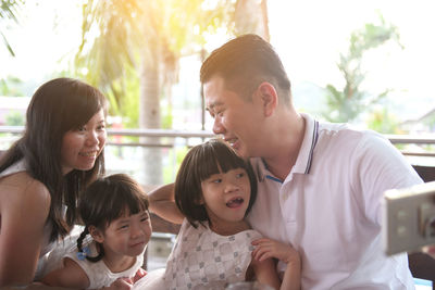 Father and daughter in front of people