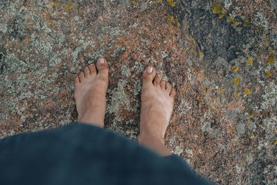 Low section of woman standing on field