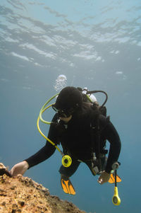 Woman scuba diving in sea