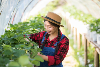 Young woman working at greenhouse