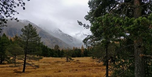 Scenic view of mountains against cloudy sky