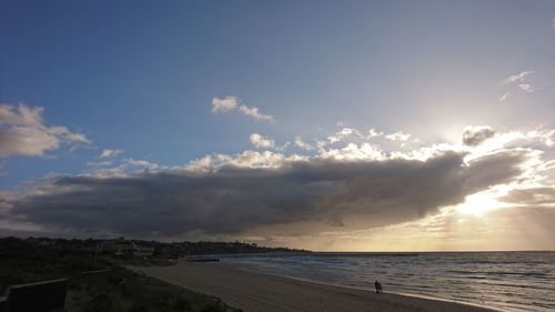 View of beach against cloudy sky