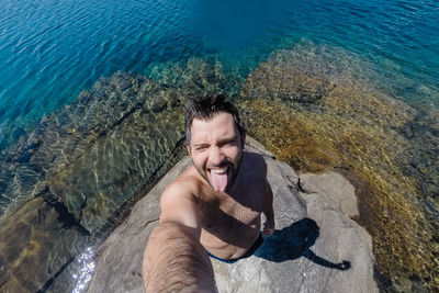 Portrait of shirtless man in swimming pool