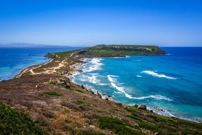 High angle view of sea shore against blue sky