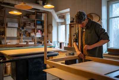 Side view of man working at workshop