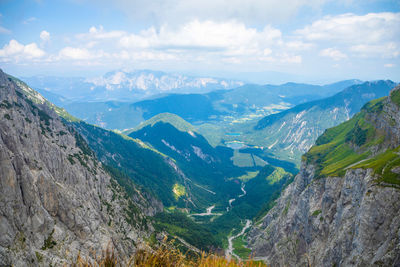 Scenic view of valley and mountains against sky