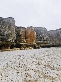 Surface level of rocks on land against sky